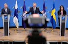 NATO Secretary-General Jens Stoltenberg, center, participates in a news conference with Finland’s Foreign Minister Pekka Haavisto, left, and Sweden�