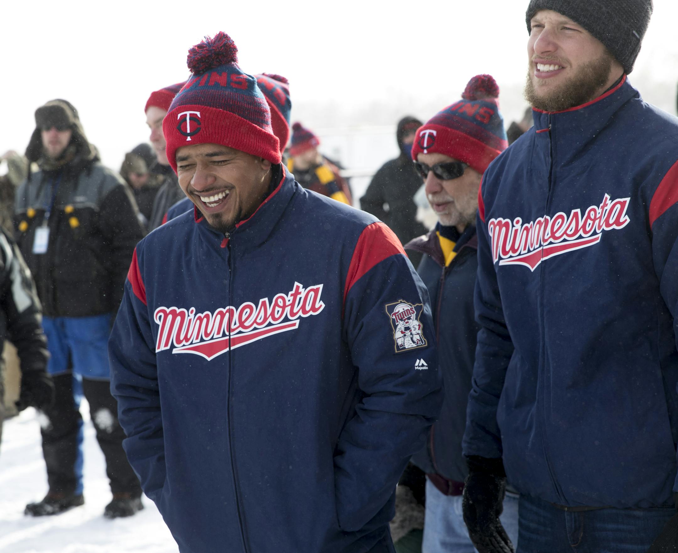 Twins shortstop Eduardo Escobar and pitcher Alan Busenitz tried to stay warm during Monday's ice fishing competition.