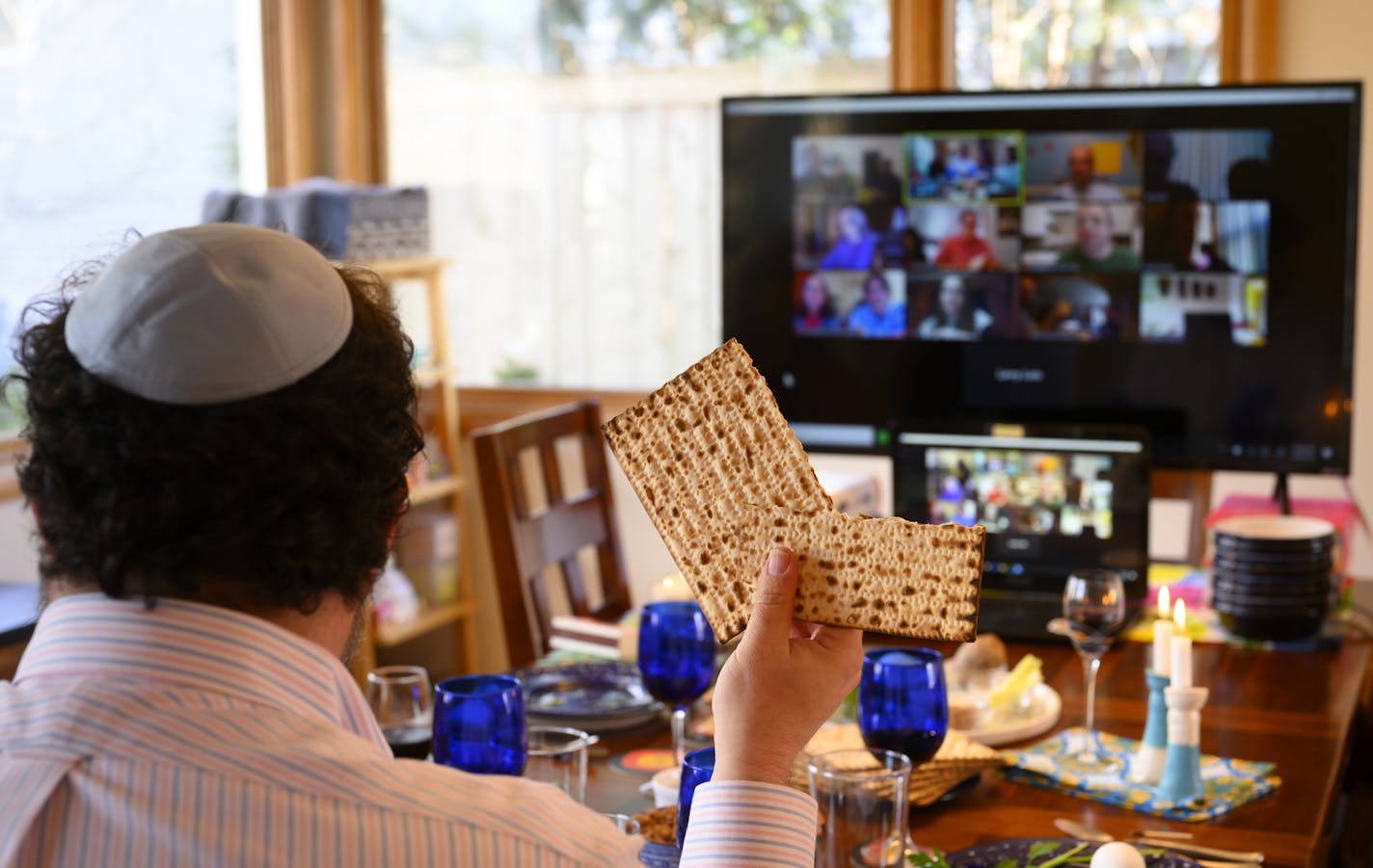 Bruce Manning held up matzo, which he just broke in half as part of Passover seder ritual, as he took part in a virtual seder alongside his family Wednesday night. ] Aaron Lavinsky &#x2022; aaron.lavinsky@startribune.com Shir Tikvah President Bruce Manning hosted a virtual Seder with family, friends and congregants Wednesday night in his Minneapolis home alongside his wife, Tricia Cornell, and their kids, Nora, 17, and Arlo, 15.