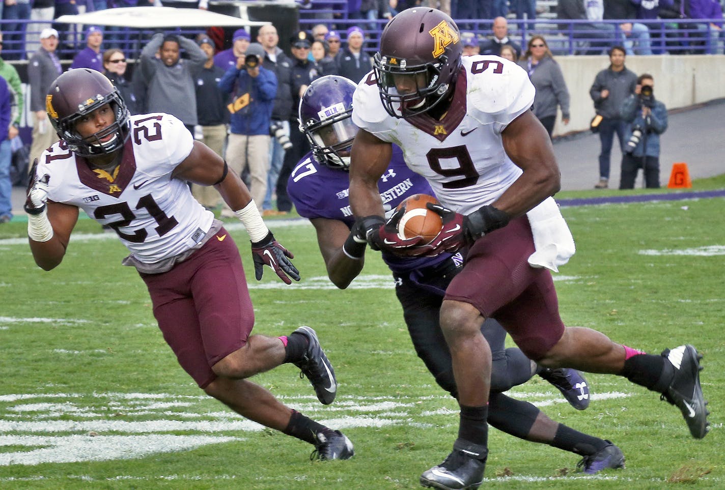 Minnesota linebacker James Manuel headed for the end zone and a touchdown after intercepting a Northwestern pass in 2nd half action putting the Gophers ahead 14-7