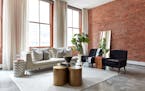 A leaning mirror is placed against a brick wall in an industrial-style loft living space. (Scott Gabriel Morris/Handout/TNS)