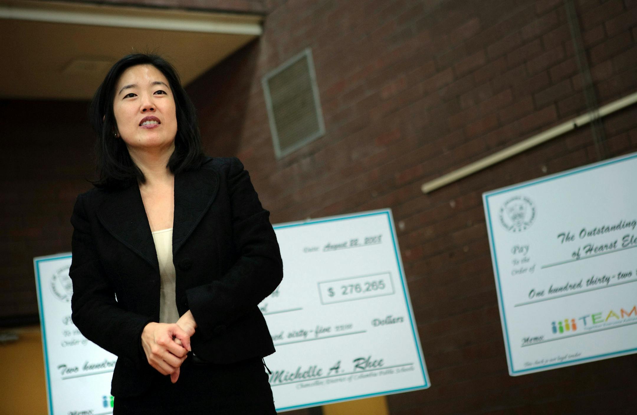 (NYT54) WASHINGTON -- Nov. 12, 2008 -- D.C.-SCHOOLS-TENURE-2 -- Washington public schools Chancellor Michelle Rhee looks on during an awards ceremony at the Winston School, October 23, 2008 in Washington, D.C. Rhee thinks teacher tenure may be great for adults -- those who go into teaching to get cushy summer vacations and great health insurance, for instance. But it hurts children, she says, by making incompetent instructors harder to fire. So Rhee has proposed spectacular raises of as much as