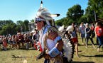 Reuben Crow Feather, with the Standing Rock Sioux Tribe, helped lead a round dance in a powwow Saturday at the Eaux Claires Music and Art Festival. ] 