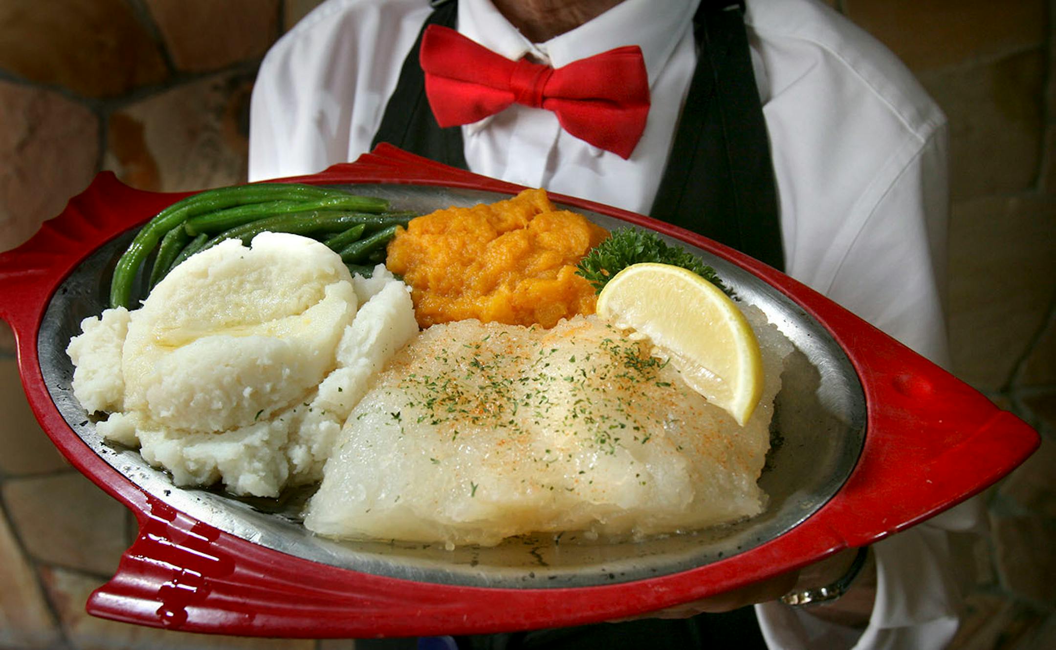 Tom Wallace Ô twallace@comcast.net Judy Lawton from Pearsons hold the holiday special Lutefisk plate that the restaurant serves through the holiday season. They will sell about 50 pounds in an avearge week. Pearson's Edina Restaurant, 3808 West 50th Street. 612 927 4464.