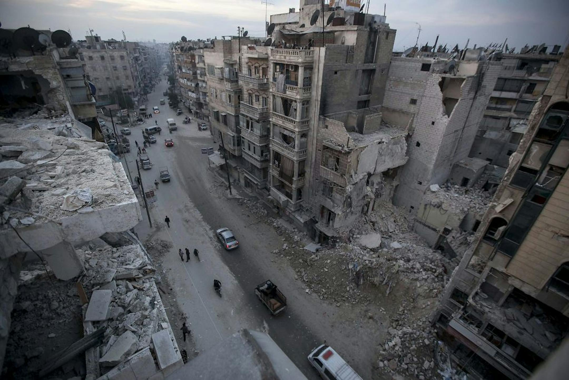 In this Thursday, Nov. 29, 2012 photo, destroyed buildings, including Dar Al-Shifa hospital, are seen on Sa'ar street after airstrikes targeted the area in Aleppo, Syria.
