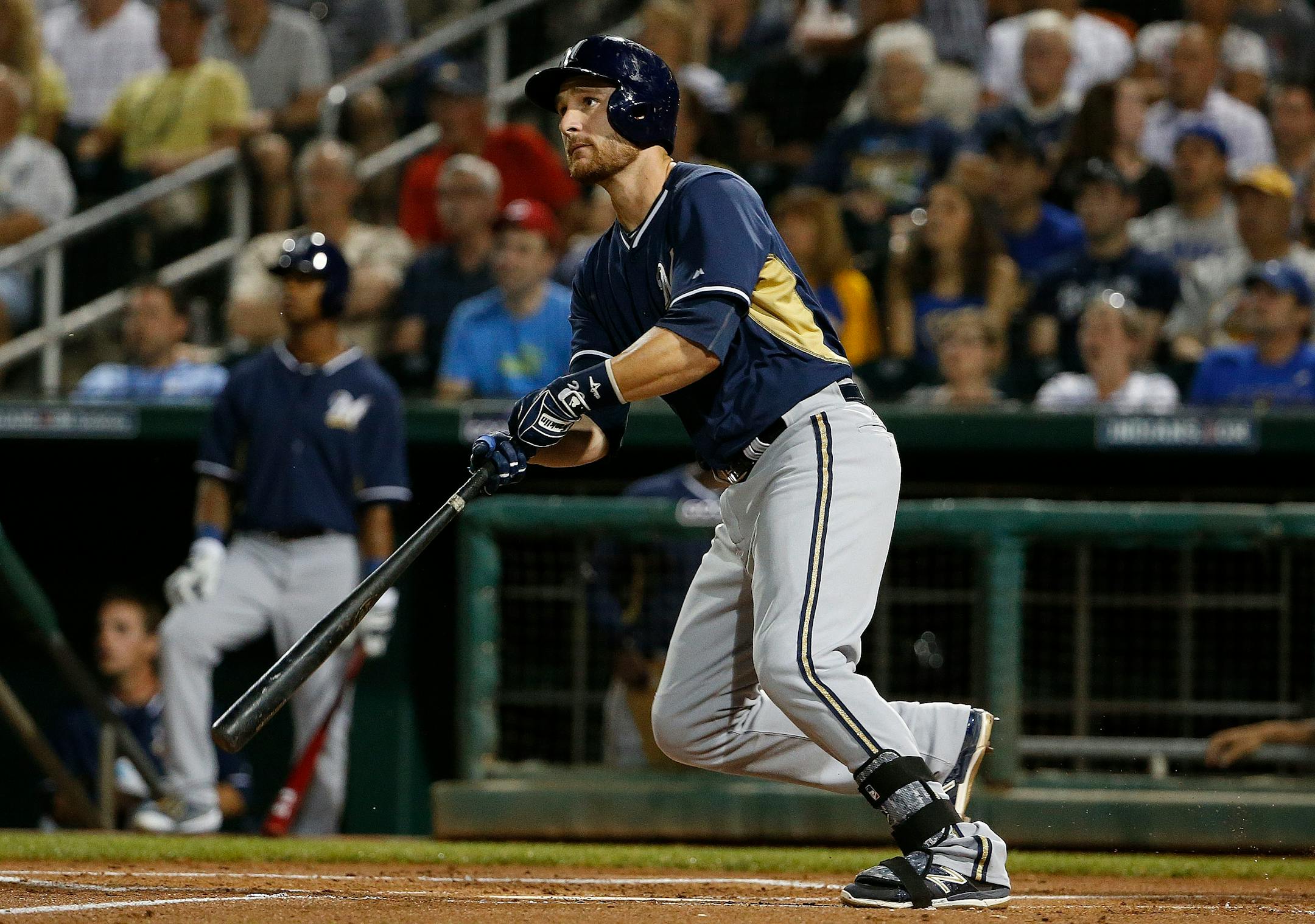 Milwaukee Brewers' Jonathan Lucroy watches his two-run home run against the Cincinnati Reds during the first inning of a spring training baseball game Friday, March 27, 2015, in Goodyear, Ariz. (AP Photo/Ross D. Franklin)