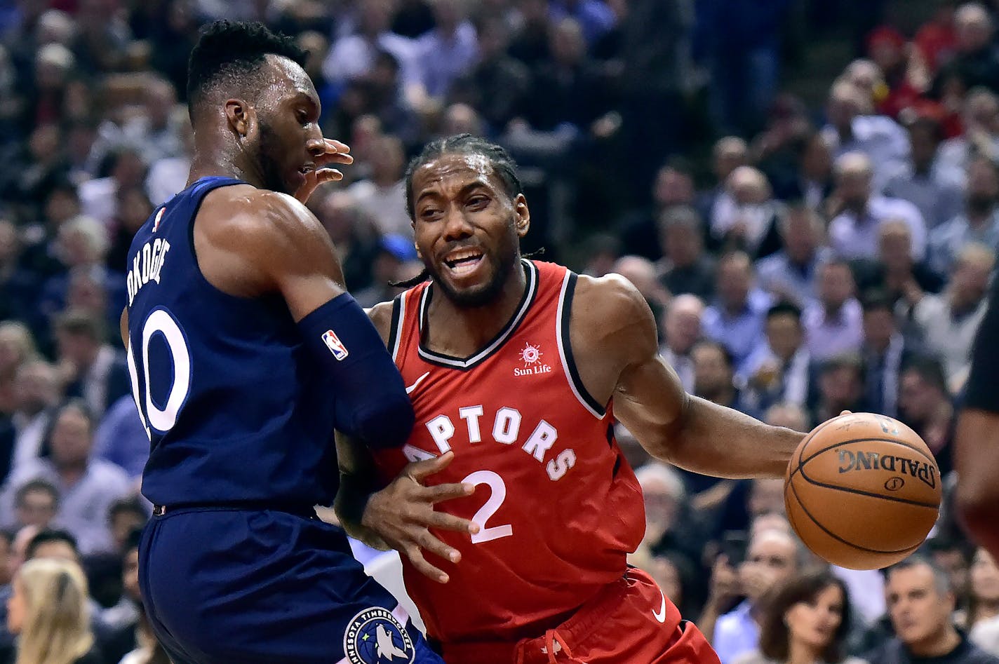 Raptors forward Kawhi Leonard tries to get around Timberwolves guard Josh Okogie during the first half