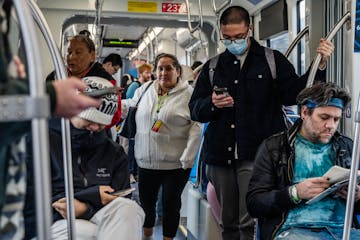 Riders board the Green Line in Minneapolis on Nov. 6. Metro Transit buses and Metro Blue, Green and Red lines will follow regular schedules on Preside