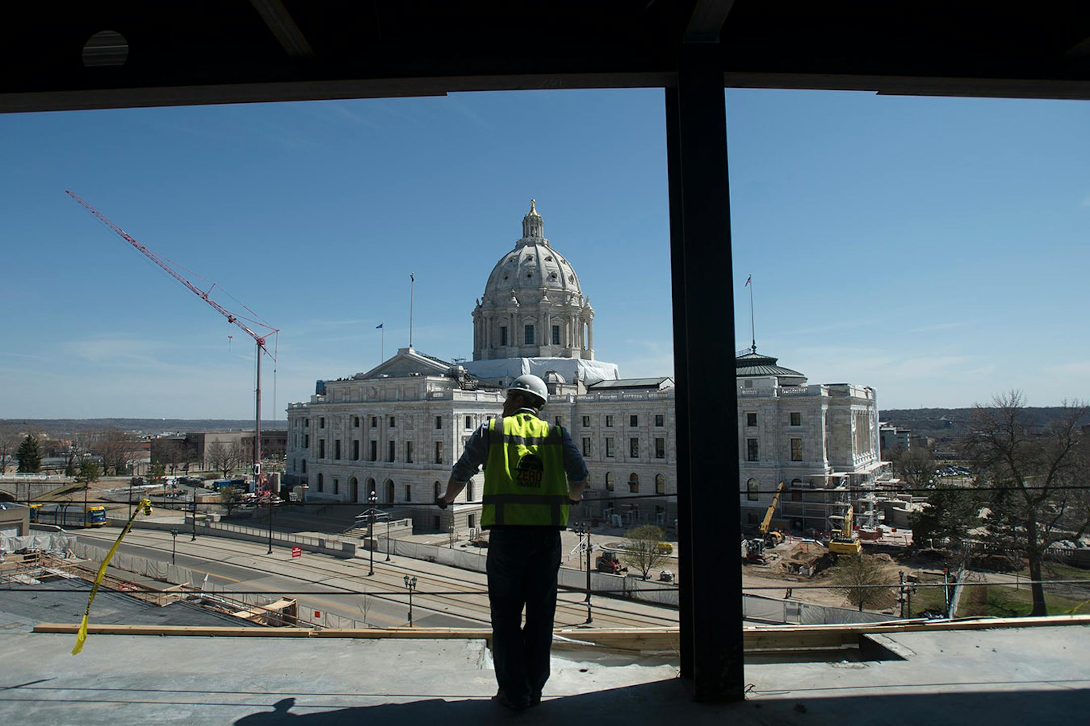 Greg Huber, senior project manager with Mortensen Construction overseeing the Senate Office Building project, looks on while standing on the top floor of the new building on Tuesday afternoon.