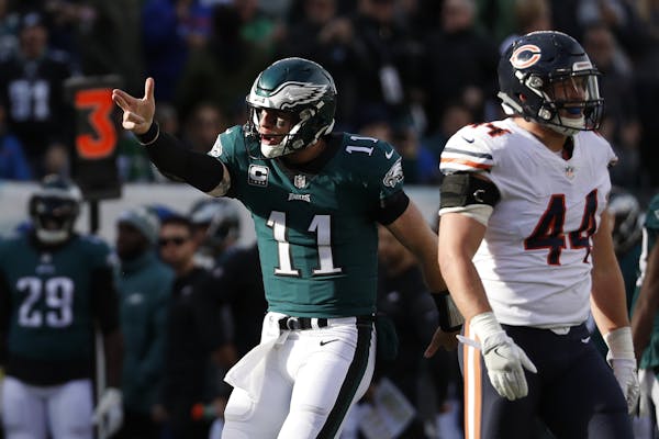 Philadelphia Eagles' Carson Wentz (11) reacts after running for a first down during the first half of an NFL football game against the Chicago Bears, 