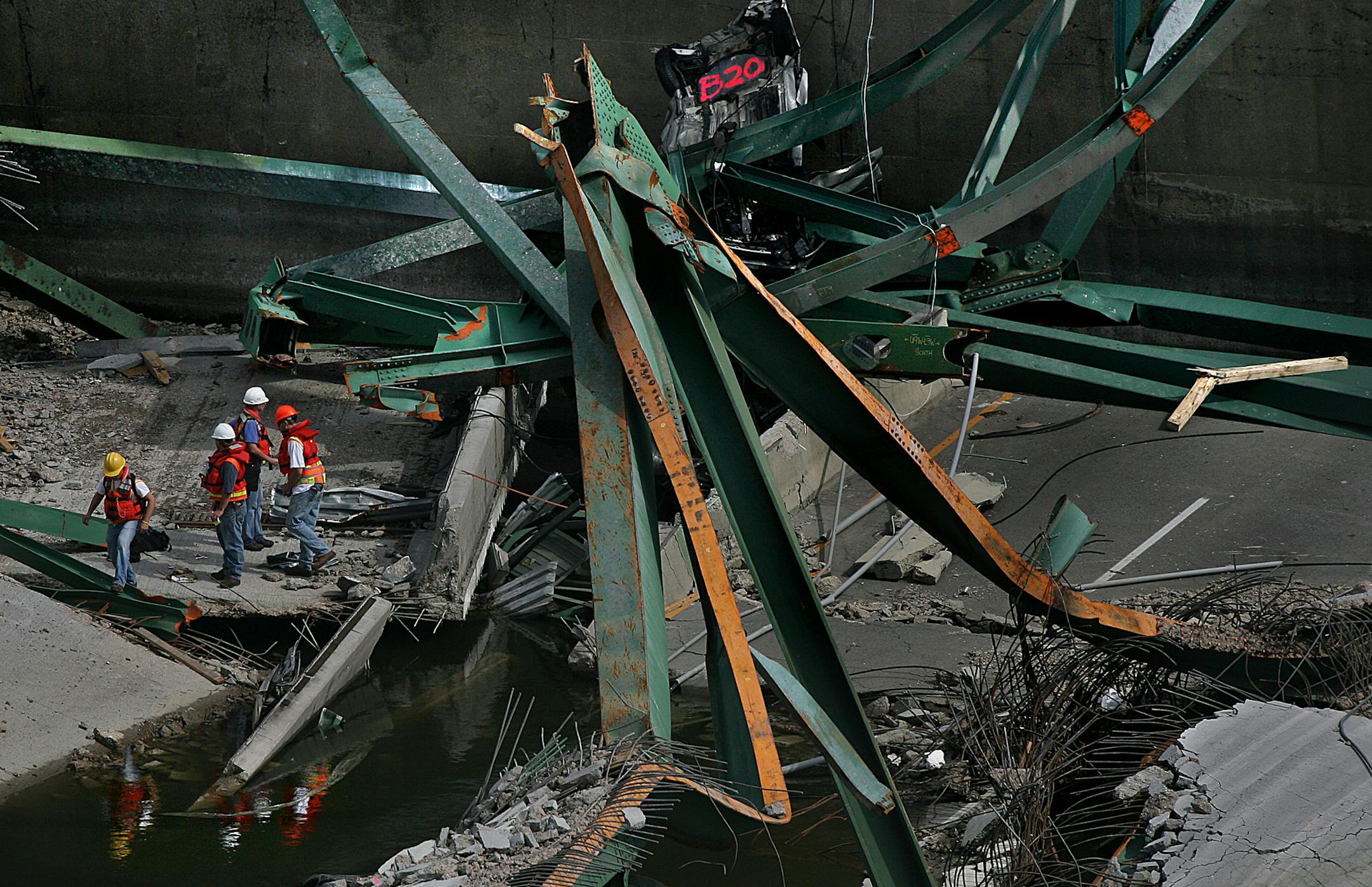 JIM GEHRZ • jgehrz@startribune.com
Minneapolis/August 11, 2007/11:00AM
The reflections of workmen are cast in standing waters at the site of the I-35W bridge collapse as investigation, evaluation and recovery efforts continue.