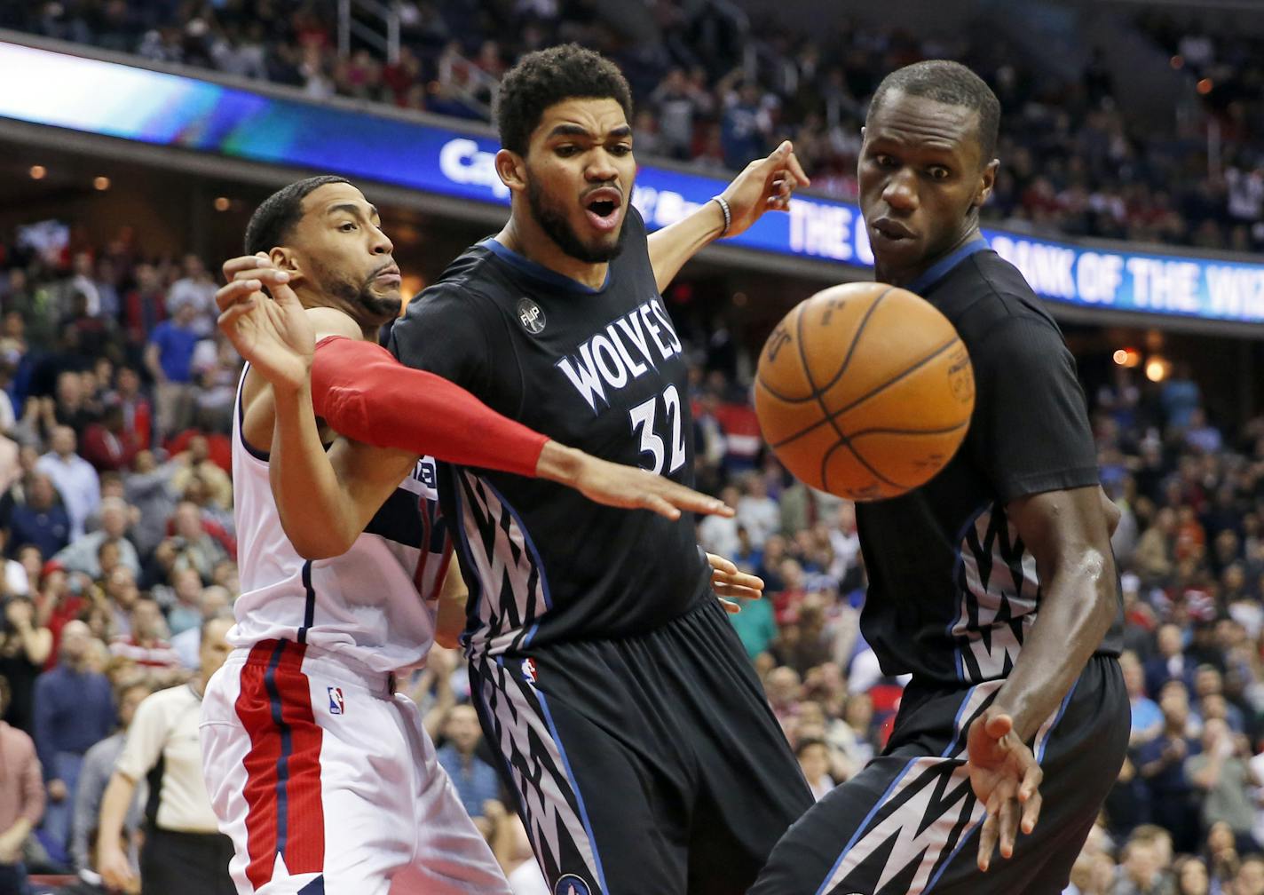 Washington Wizards guard Garrett Temple, left, and Minnesota Timberwolves center Karl-Anthony Towns (32) and center Gorgui Dieng go for the rebound during the second overtime of an NBA basketball game Friday, March 25, 2016, in Washington. The Timberwolves won 132-129. (AP Photo/Alex Brandon)