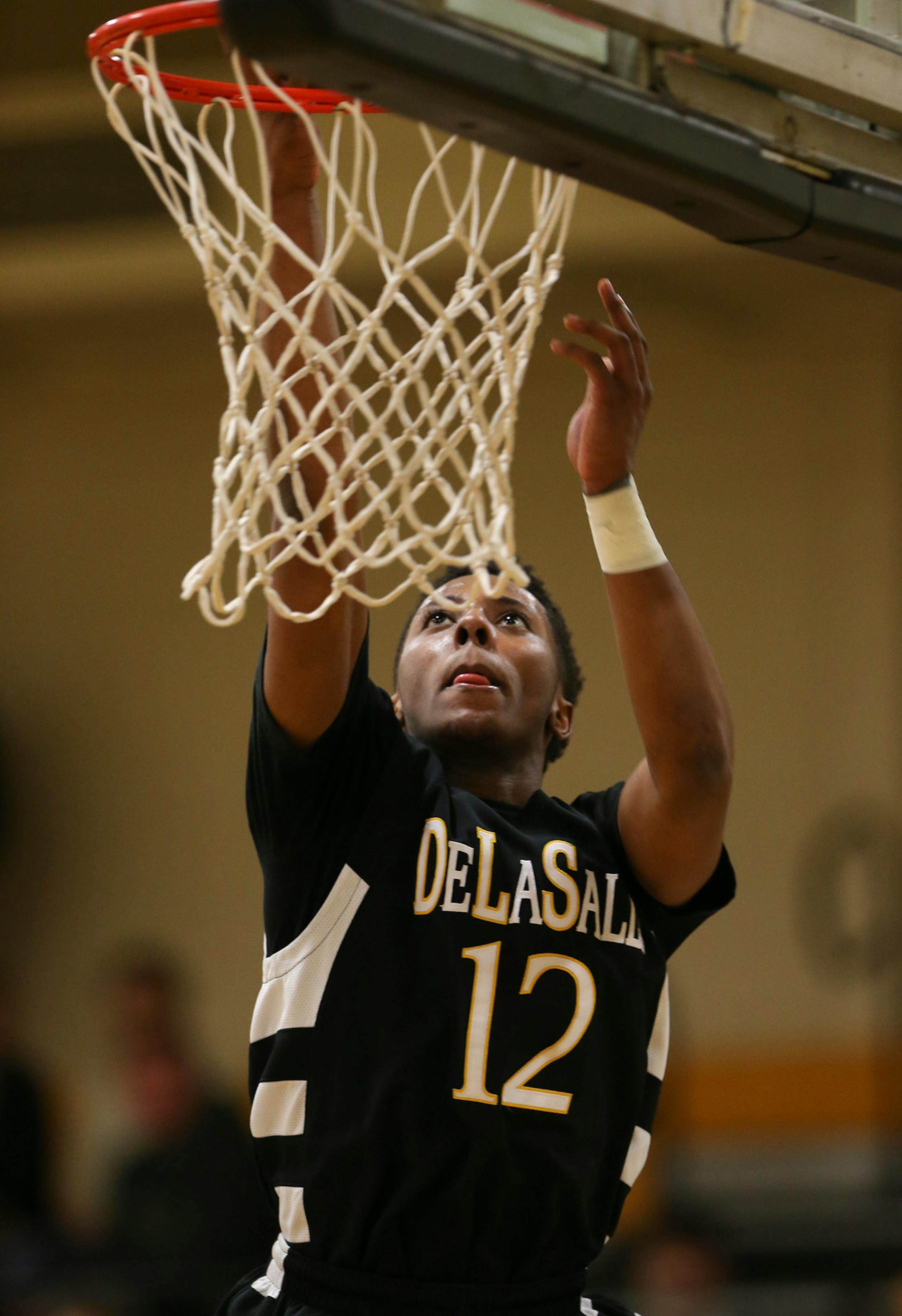 DeLaSalle's Jarvis Johnson with a second half layup against Fridley at DeLaSalle ] JEFF WHEELER ï jeff.wheeler@startribune.com DeLaSalle High School trounced Fridley 69-31 in a boy's basketball game Thursday night, February 12, 2015 at DeLaSalle. The Islanders' Jarvis Johnson is the top preps hoops player in the state and the Gophers' No. 1 recruit for 2015.