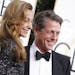 Hugh Grant and Anna Elisabet Eberstein arrive at the 74th Annual Golden Globe Awards show at the Beverly Hilton Hotel in Beverly Hills, Calif., on Sun