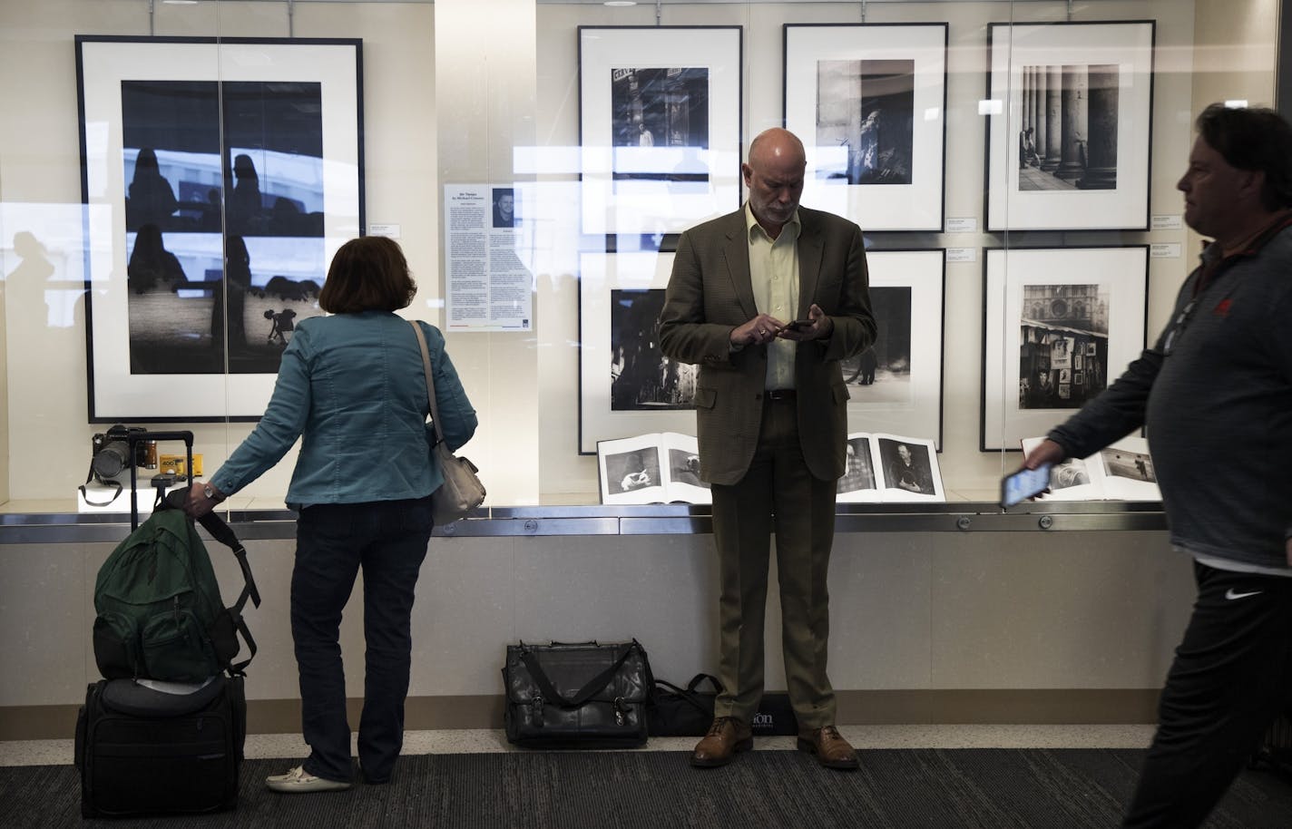 Passengers walked by Michael Crouser's exhibit "Sin Tiempo."