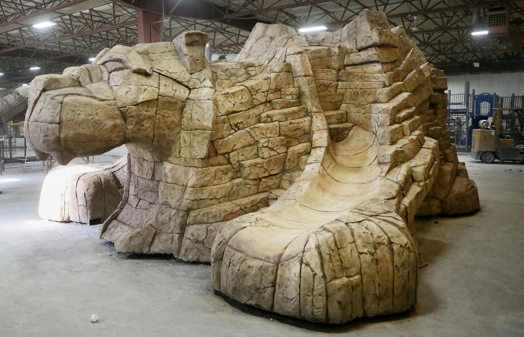 Themed Concepts, a Forest Lake business that builds and installs fiber reinforced concete playground equipment for businesses, theme parks and water parks nationally and internationally, recently completed this 25,000 pound mountain lion. The sculpture, made of rebar, structural steel and glass fiber reinforced concrete was seen at the plant Thursday, Feb. 19, 2015 in Forest Lake, MN and will be trucked to Phoenix, AZ, to go in a park as a playground.](DAVID JOLES/STARTRIBUNE)djoles@startribune.