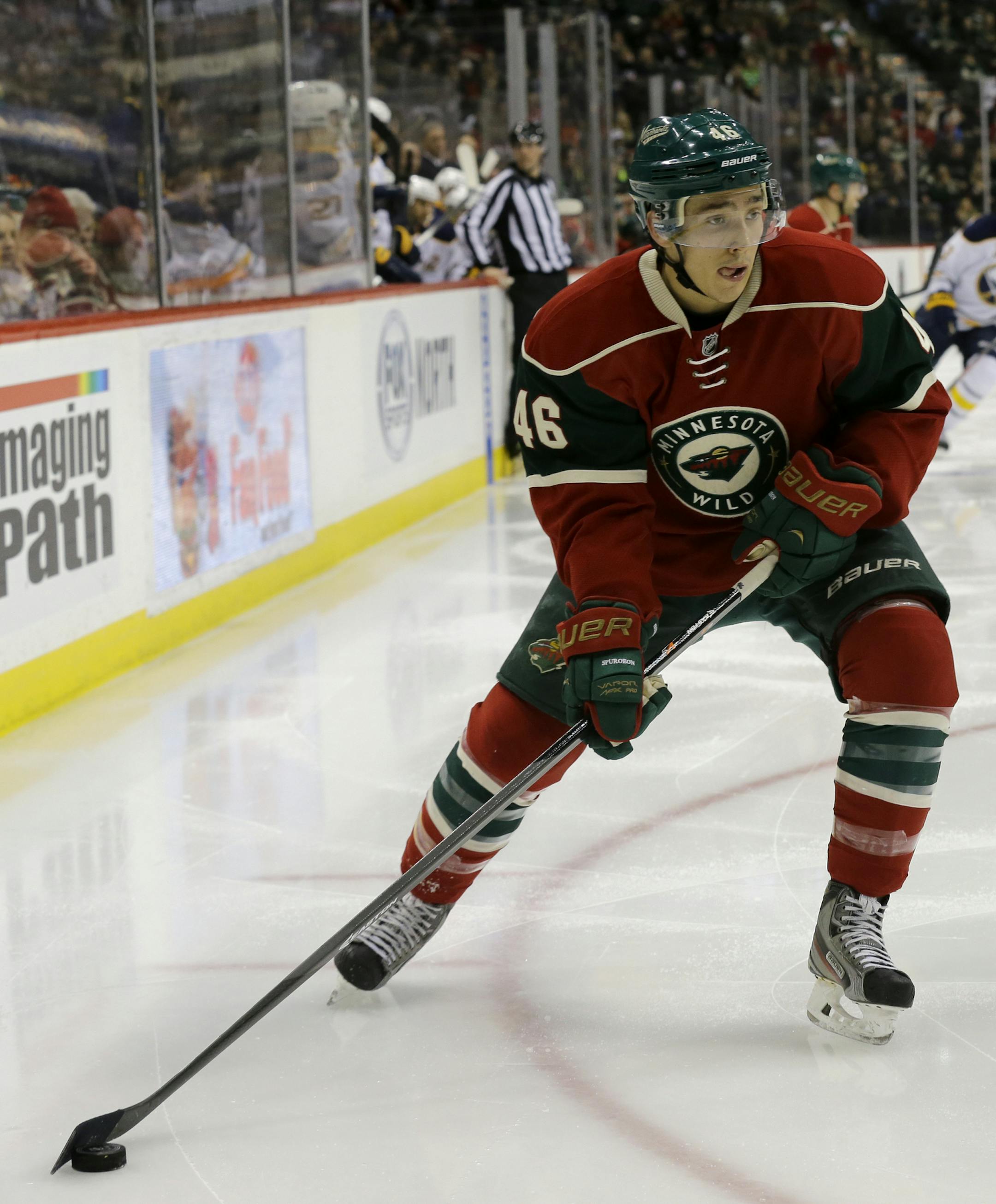 Minnesota Wild defenseman Jared Spurgeon (46) controls the puck during the second period of an NHL hockey game against the Buffalo Sabres in St. Paul, Minn., Thursday, Jan. 2, 2014. (AP Photo/Ann Heisenfelt)