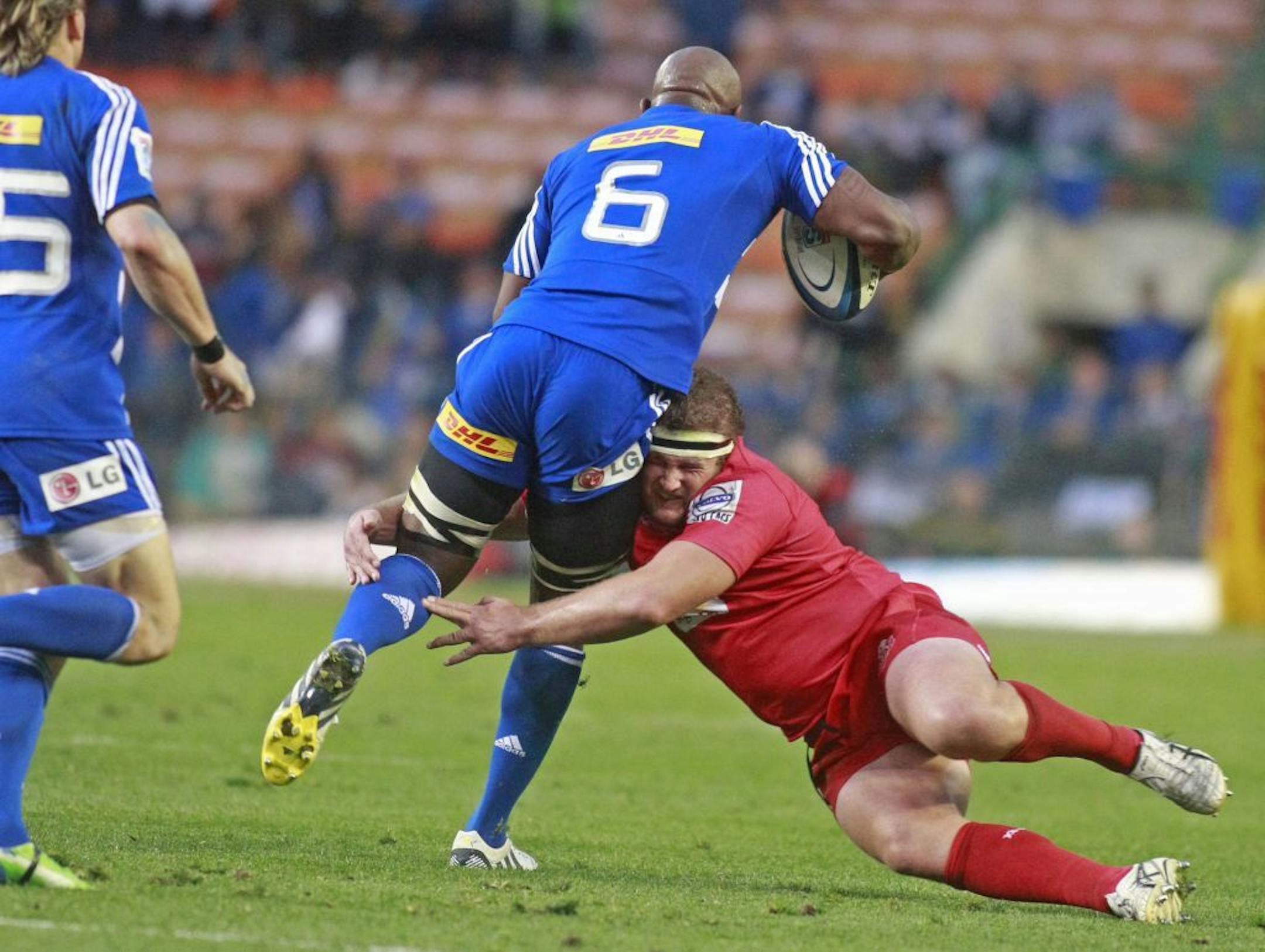 Australian Reds player James Slipper, right, fights for the ball with South African Stormer Siyamthanda Kolisi, center, during their Super Rugby game in Cape Town, South Africa, Saturday, May 25, 2013.