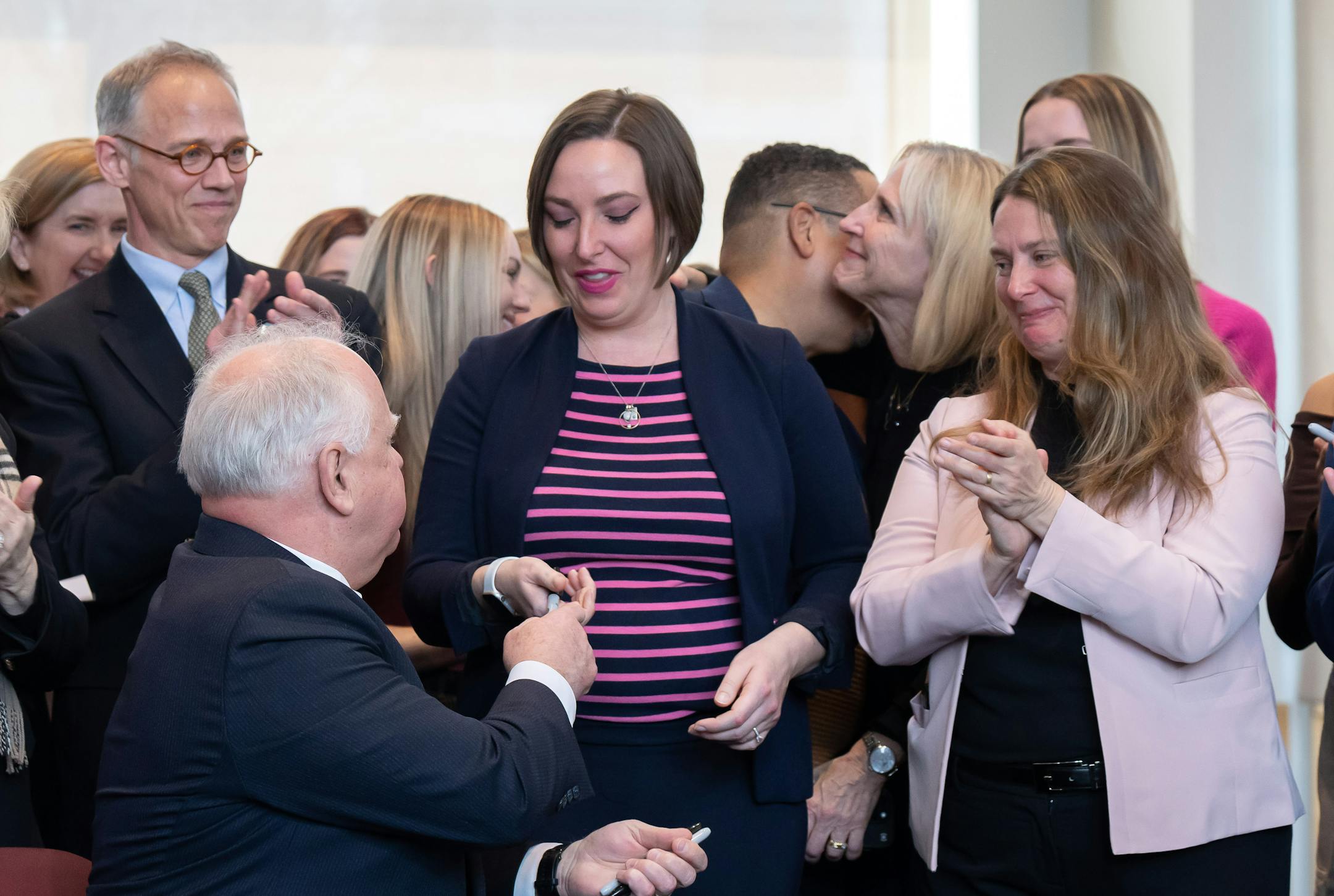 After signing the bill, Gov. Tim Walz handed signing pens to bill authors Rep. Carlie Kotyza-Witthuhn, DFL-Eden Prairie and Sen. Jennifer McEwen, DFL-Duluth.
