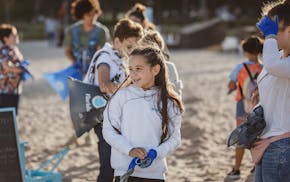 Sasha Olsen, 10, during a January beach cleanup at Bal Harbour that she organized through the nonprofit she created with her cousin, Iwantmyoceanback.