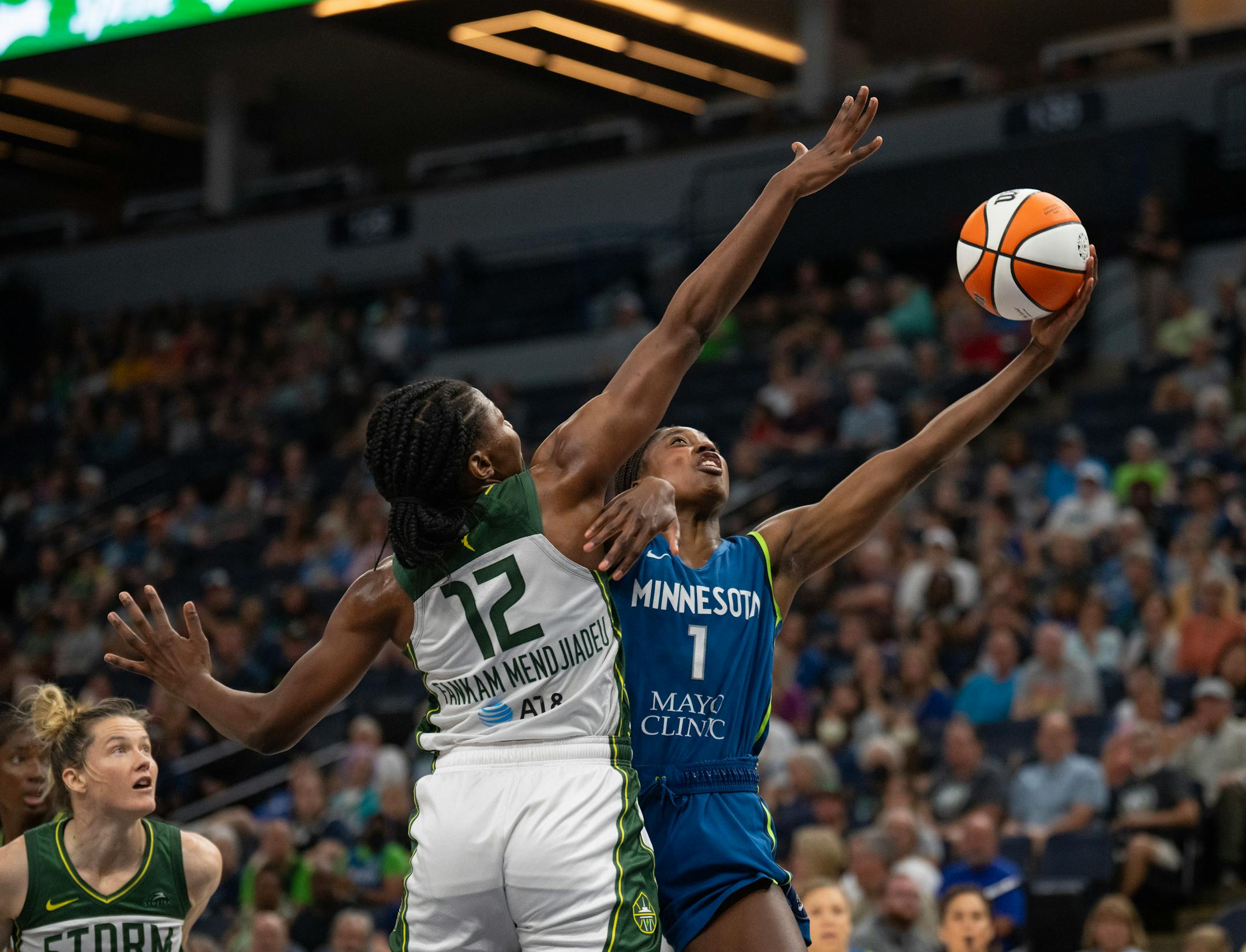 Lynx guard Diamond Miller put up a shot around the defense of Seattle Storm forward Dulcy Fankam Mendjiadeu in the first quarter.