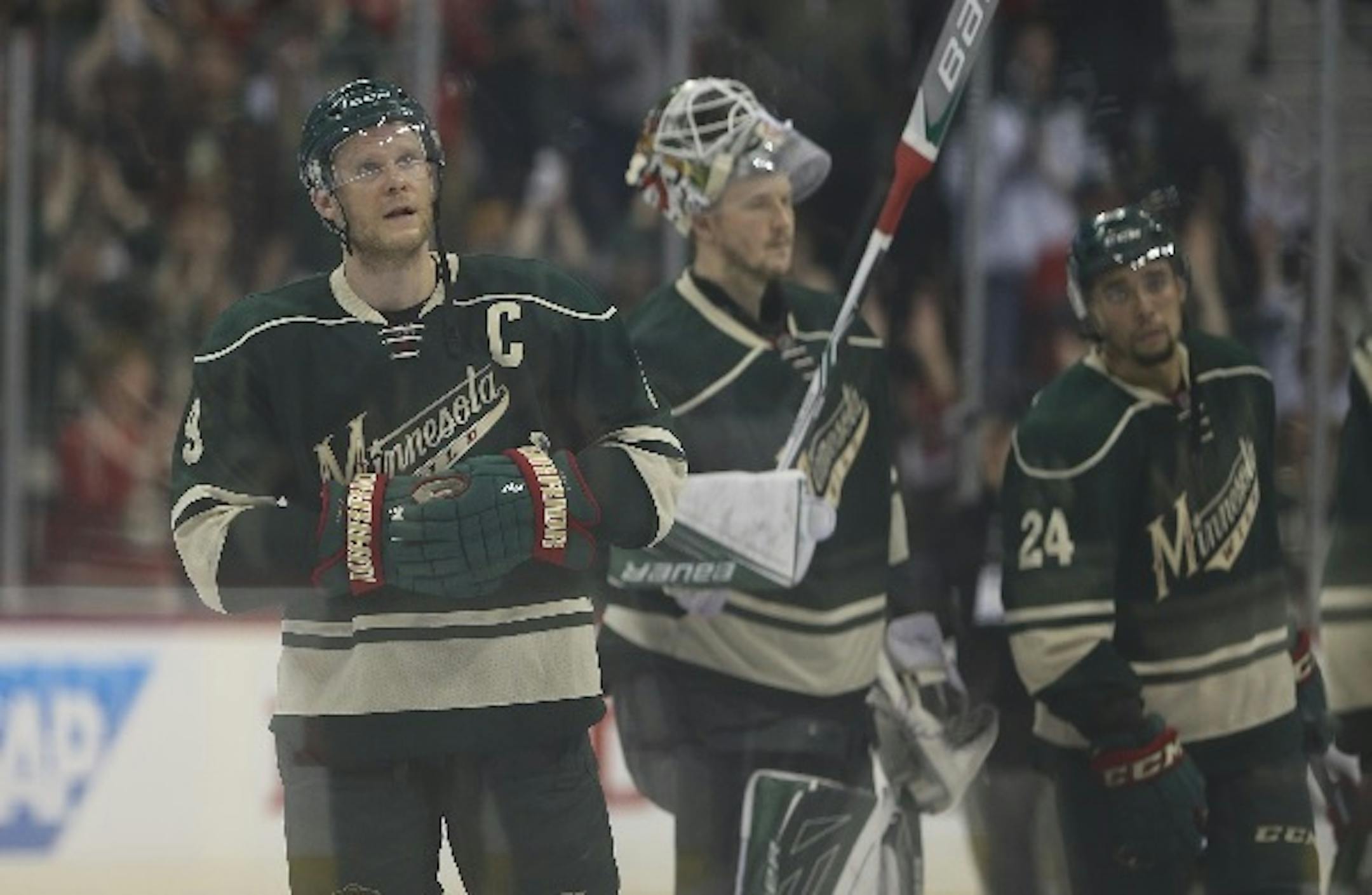 Wild captain Mikko Koivu (9) stood at center ice as he and his teammates saluted the Xcel Energy Center fans after the game Sunday.