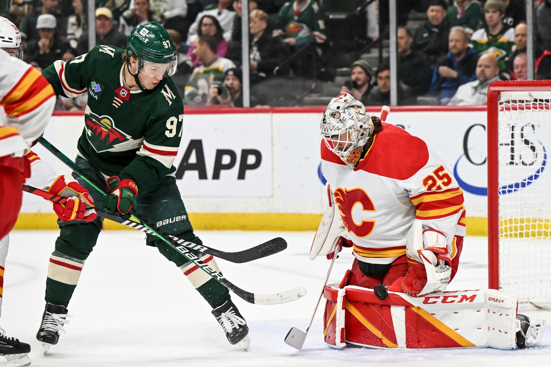 Minnesota Wild left wing Kirill Kaprizov (97) is unable to score off a rebound as Calgary Flames goaltender Jacob Markstrom (25) makes a save during the second period.
