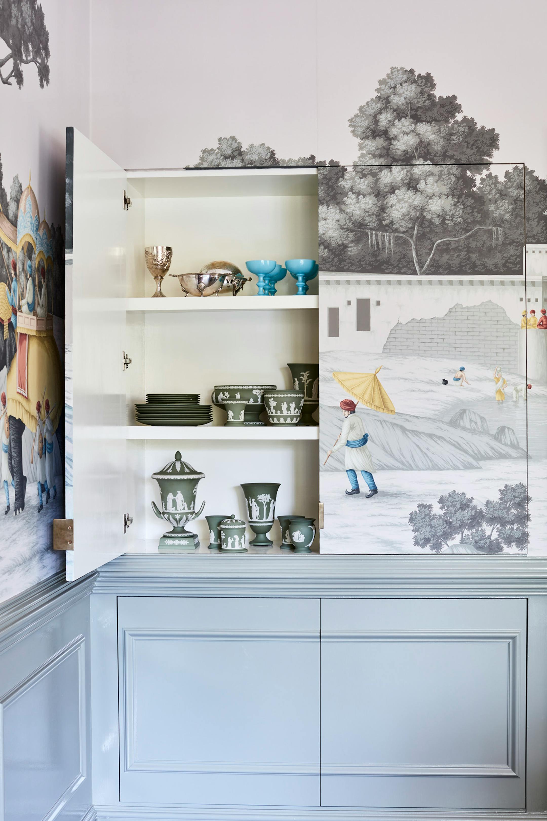 Although she kept most of the home's original details, Leah O'Connell did reconfigure the dining room's built-in shelving by creating jib doors, allowing for a greater expanse of wallpaper. MUST CREDIT: Anna Williams