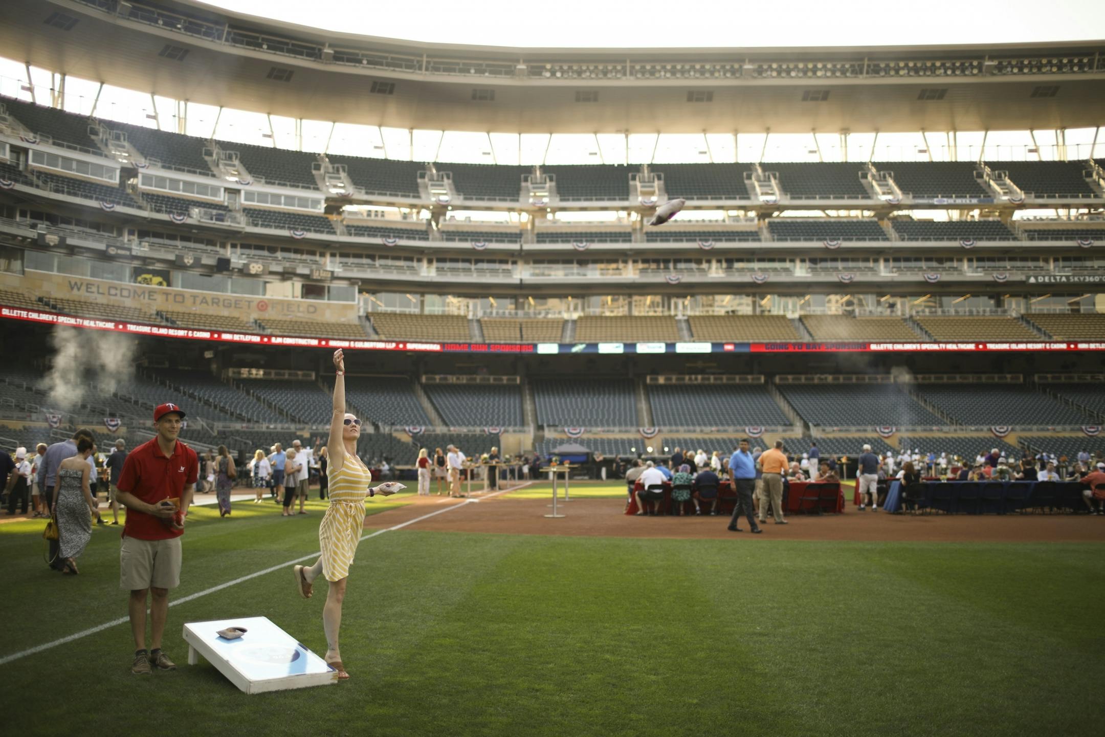 Cole Pederson and Natasha Bourgoin played cornhole in right field during the Twins' 1987 Summer Celebration in 2017.