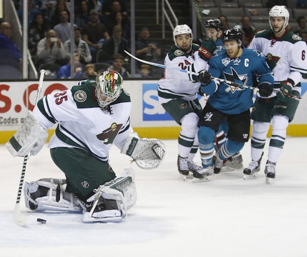 Minnesota Wild goalie Darcy Kuemper finds the puck behind him after a shot by the San Jose Sharks in the first period at SAP Arena in San Jose, Calif.
