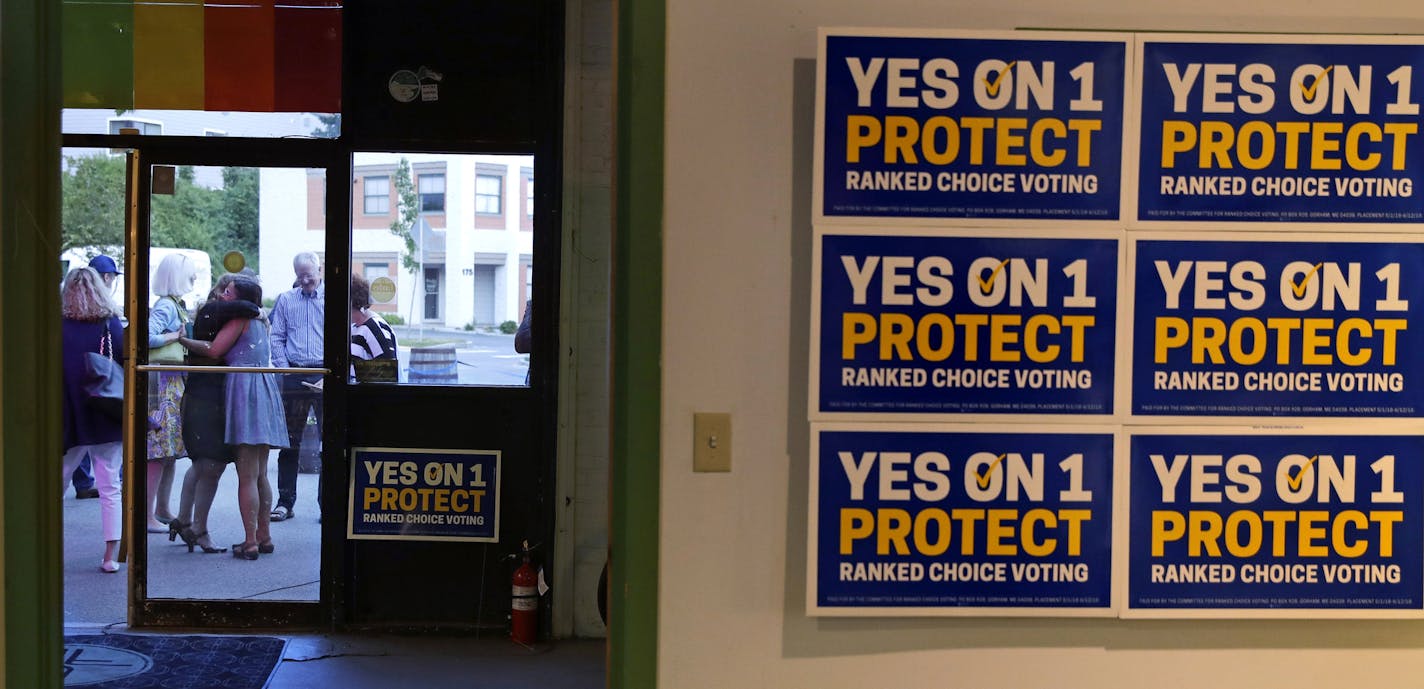 Supporters of the ranked-choice voting system embrace outside their primary night rally shortly after polls closed in Portland, Maine, Tuesday, June 12, 2018. Maine voters didn't just select their favorite candidates, they ranked the candidates from first to last using the system for the first time in statewide primaries. (AP Photo/Charles Krupa)