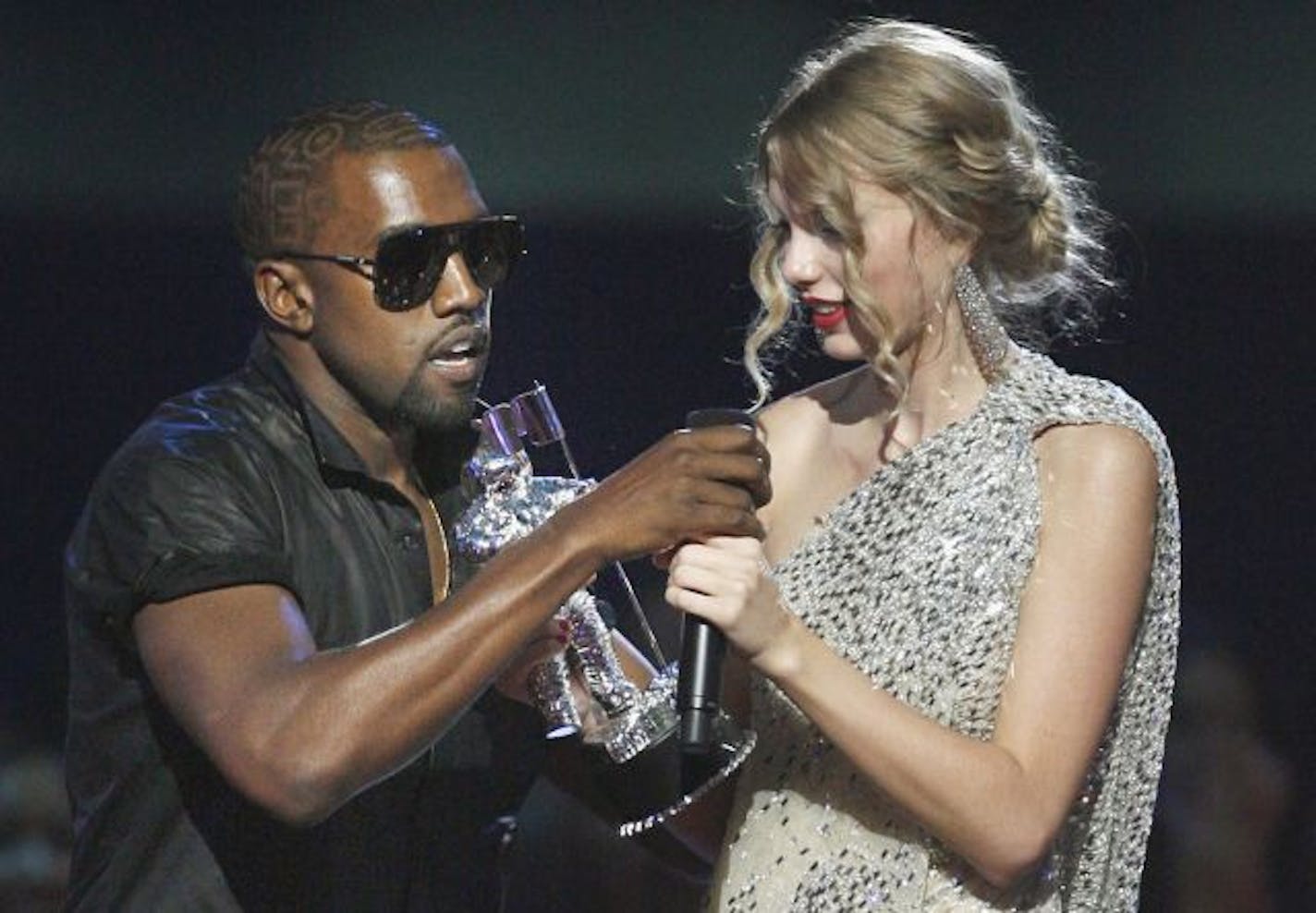 Singer Kanye West takes the microphone from singer Taylor Swift as she accepts the "Best Female Video" award during the MTV Video Music Awards on Sunday, Sept. 13, 2009 in New York.