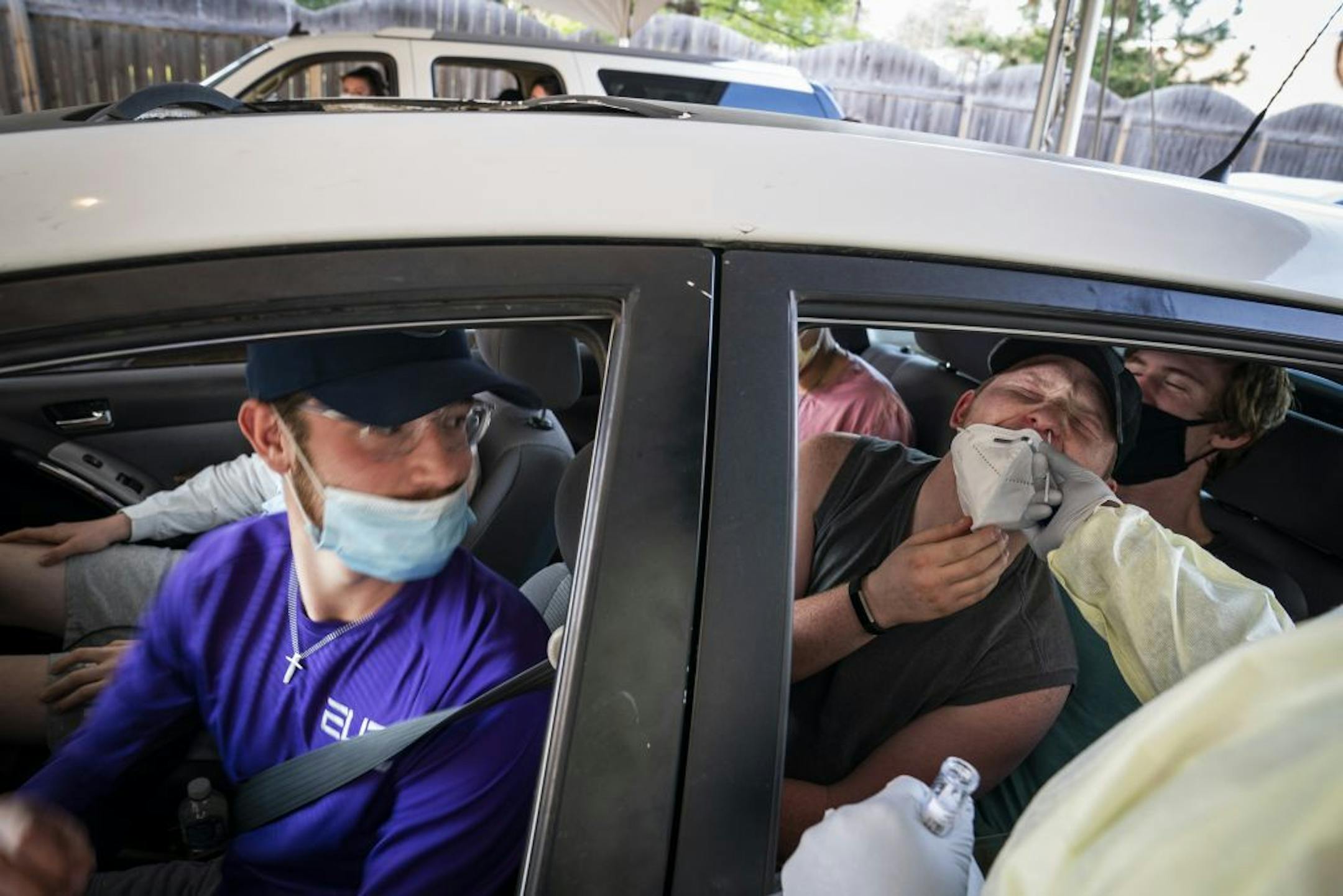 Caleb Ankrum, right, 22, with Britton Peterson, left, 21, and other friends, all students at North Central University in Minneapolis, got tested with friends who had all been exposed to someone COVID-19 positive, at the drive-through COVID-19 testing site at North Memorial Health in Robbinsdale.
