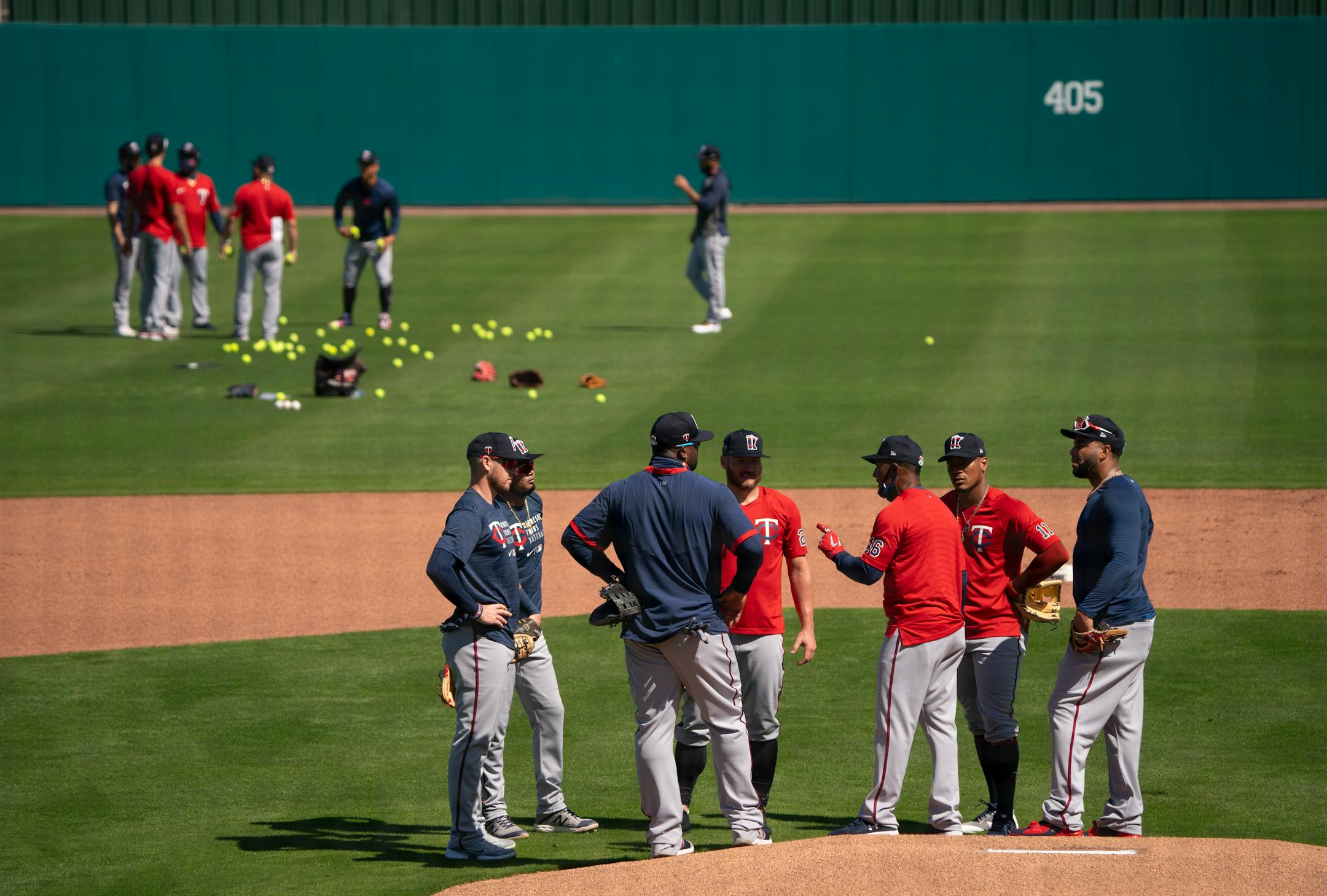 Twins third base coach Tony Diaz explained drill for infielders during the first full squad workout Tuesday morning.