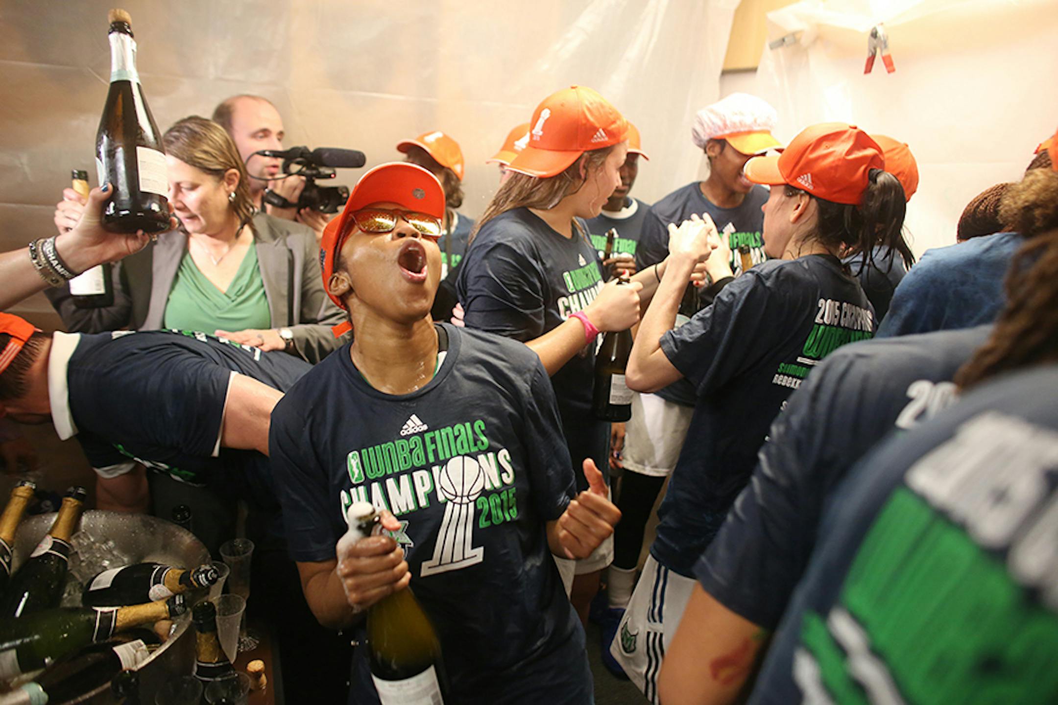 The Minnesota Lynx celebrate winning the WNBA title with champagne.