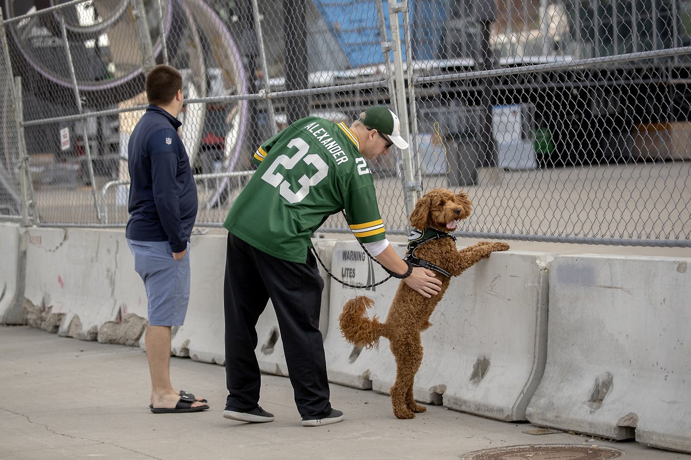 Packers fans Derek Krumrei and his dog "Reuben" and his friend Tyler Schmitz, left, checked out an empty scene before the Vikings took on the Green Bay Packers at US Bank Stadium, Sunday, September 13, 2020 in Minneapolis, MN. Fowler moved here from Florida after buying season tickets.