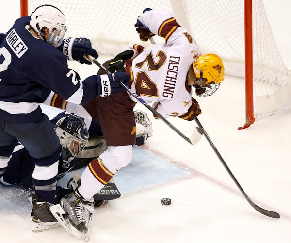 The University of Minnesota's Hudson Fasching (24) can't get the puck past Penn State goalie Eamon McAdam during the second period at Mariucci Arena F