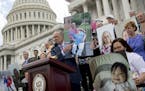 Senate Minority Leader Sen. Chuck Schumer and other Democratic senators held up photos of constituents who would be hurt by the proposed Republican Se