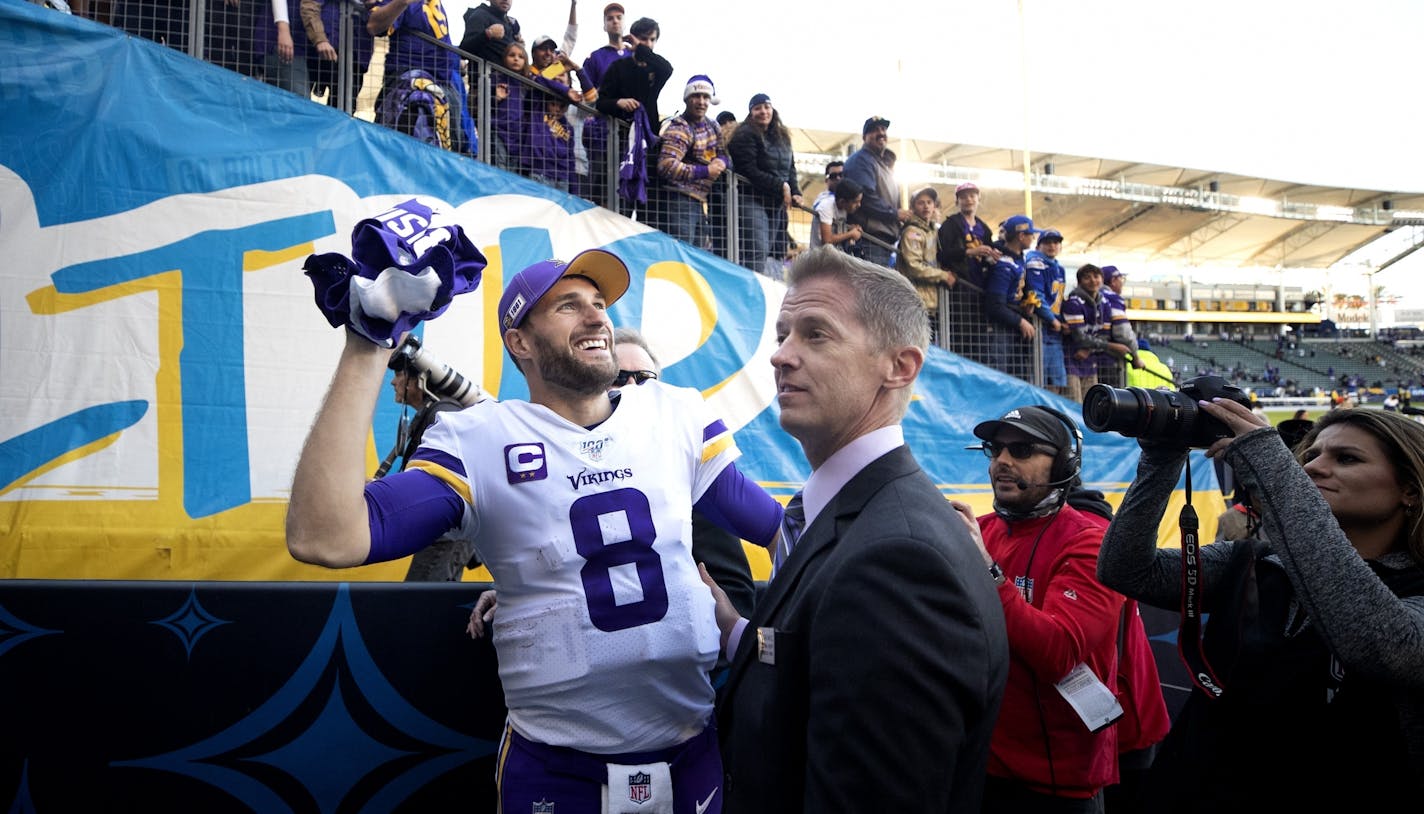 Minnesota Vikings quarterback Kirk Cousins (8) tossed a jersey to a fan at the end of the game .