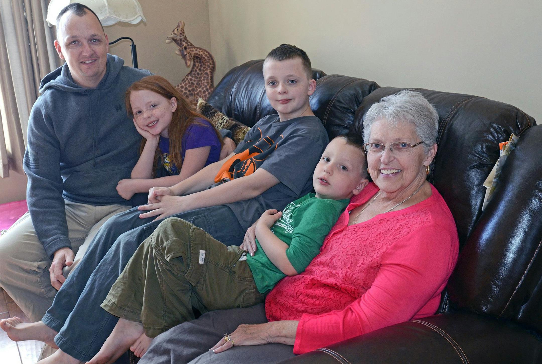 (Troy Hokanson, eight-year-old Katherine, 11-year-old Michael, five-year-old Matthew and Karen Hokanson (Troy's mother and the children's grandmother), sat on the couch in Karen Hokanson's apartment in the Hokanson's multigenerational house in Lakeville.