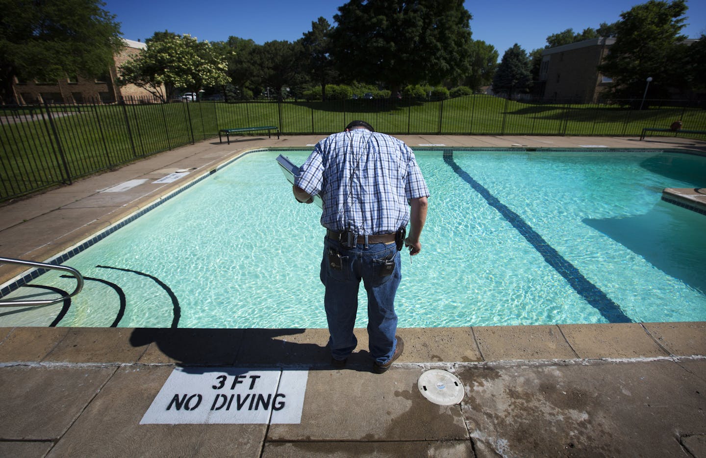 Joe Jurusik, at an apartment complex pool in Brooklyn Center, is one of the Hennepin County Environmental Health inspectors who check pools in 38 of the county&#x2019;s 45 communities.