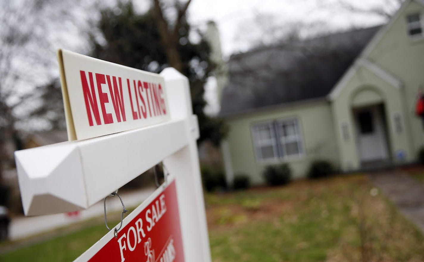 In this Tuesday, Jan. 26, 2016, photo, a "For Sale" sign hangs in front of an existing home in Atlanta. On Wednesday, Feb. 24, 2016, the Commerce Department reports U.S. home sales crept upward in January, a sign that demand for housing remains strong amid signs of slower growth across the broader economy. (AP Photo/John Bazemore)