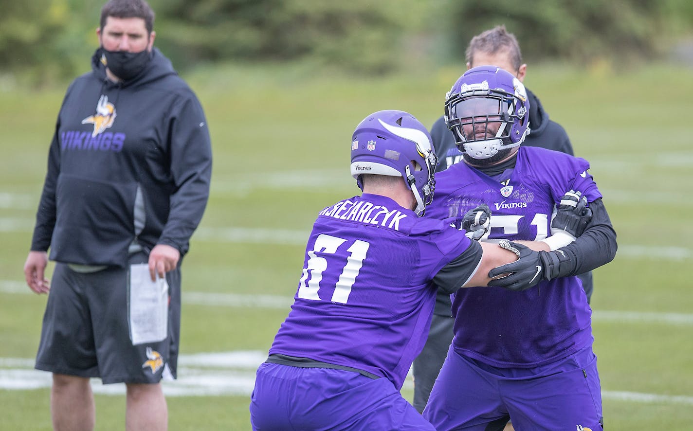 Minnesota Vikings rookies, including defensemen Evin Ksiezarczyk, front left, and Wyatt Davis practice during NFL football rookie minicamp Friday, May 14, 2021, in Eagan, Minn. (Elizabeth Flores/Star Tribune via AP)