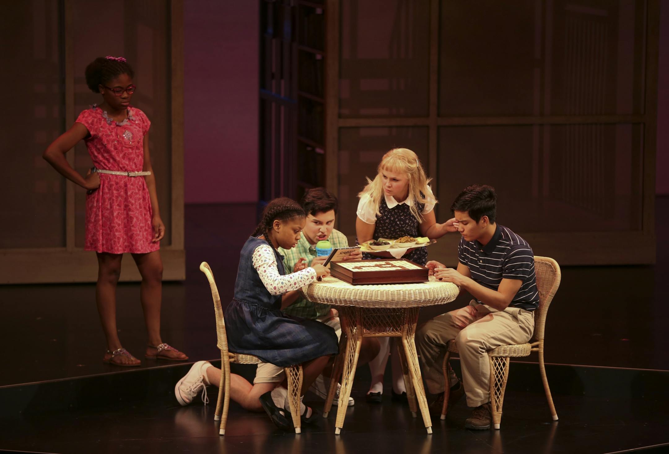 Johannah Easley as Akeelah played Sean Phinney as Dylan in a game of Scrabble as the birthday boy, Leo James as Javier announced and Ana Christine Evans as Trish held a snack tray while Zaria Graham as Georgia, fumed at left, during a first act scene at rehearsal Sunday night.