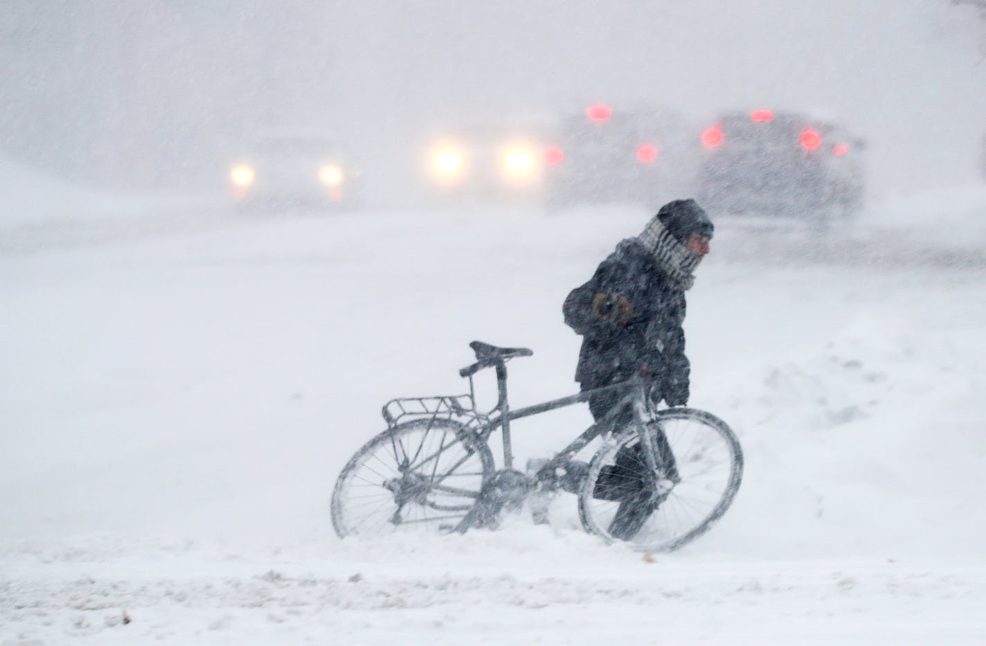 A biker navigates the snow in St. Paul.