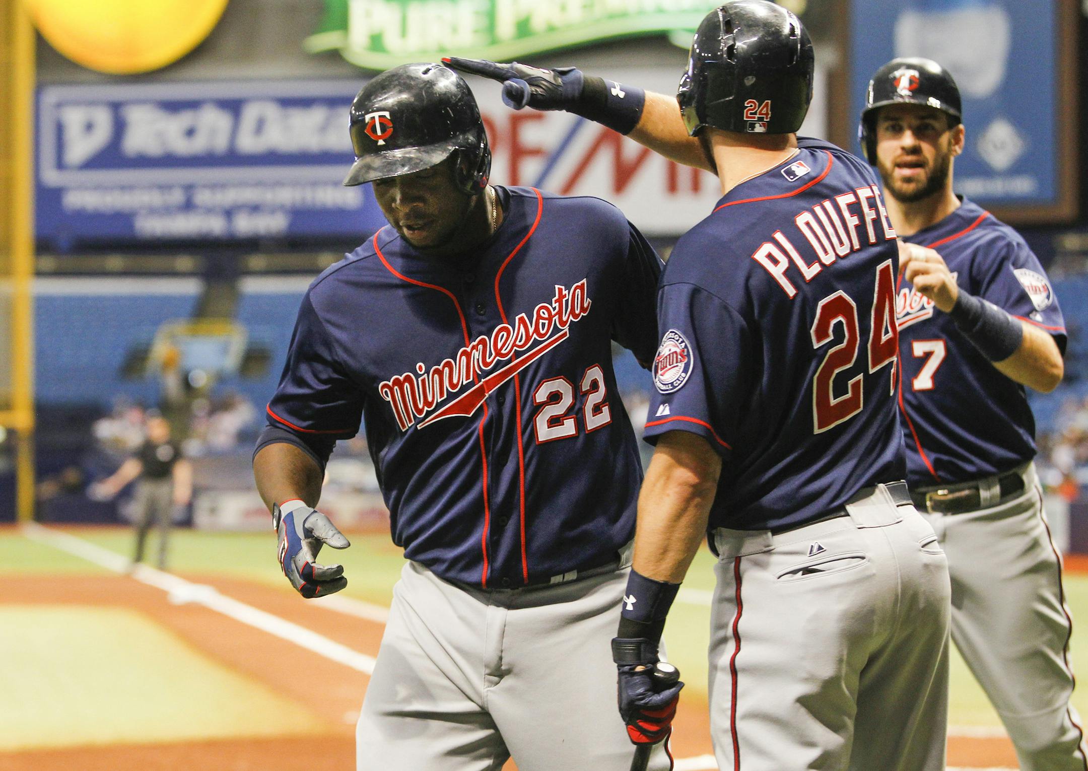 The Minnesota Twins' Trevor Plouffe (24) congratulates teammate Miguel Sano (22) on his three-run home run in the first inning against the Tampa Bay Rays at Tropicana Field in St. Petersburg, Fla., on Tuesday, Aug. 25, 2015. (Will Vragovic/Tampa Bay Times/TNS)