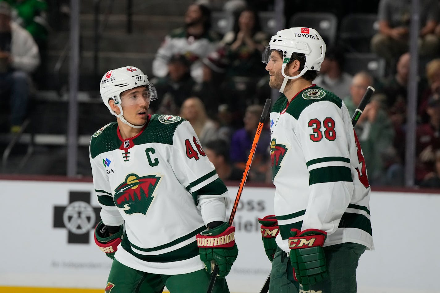 Minnesota Wild defenseman Jared Spurgeon (46) and right wing Ryan Hartman (38) in the first period during an NHL hockey game against the Arizona Coyotes, Sunday, March 12, 2023, in Tempe, Ariz. (AP Photo/Rick Scuteri)