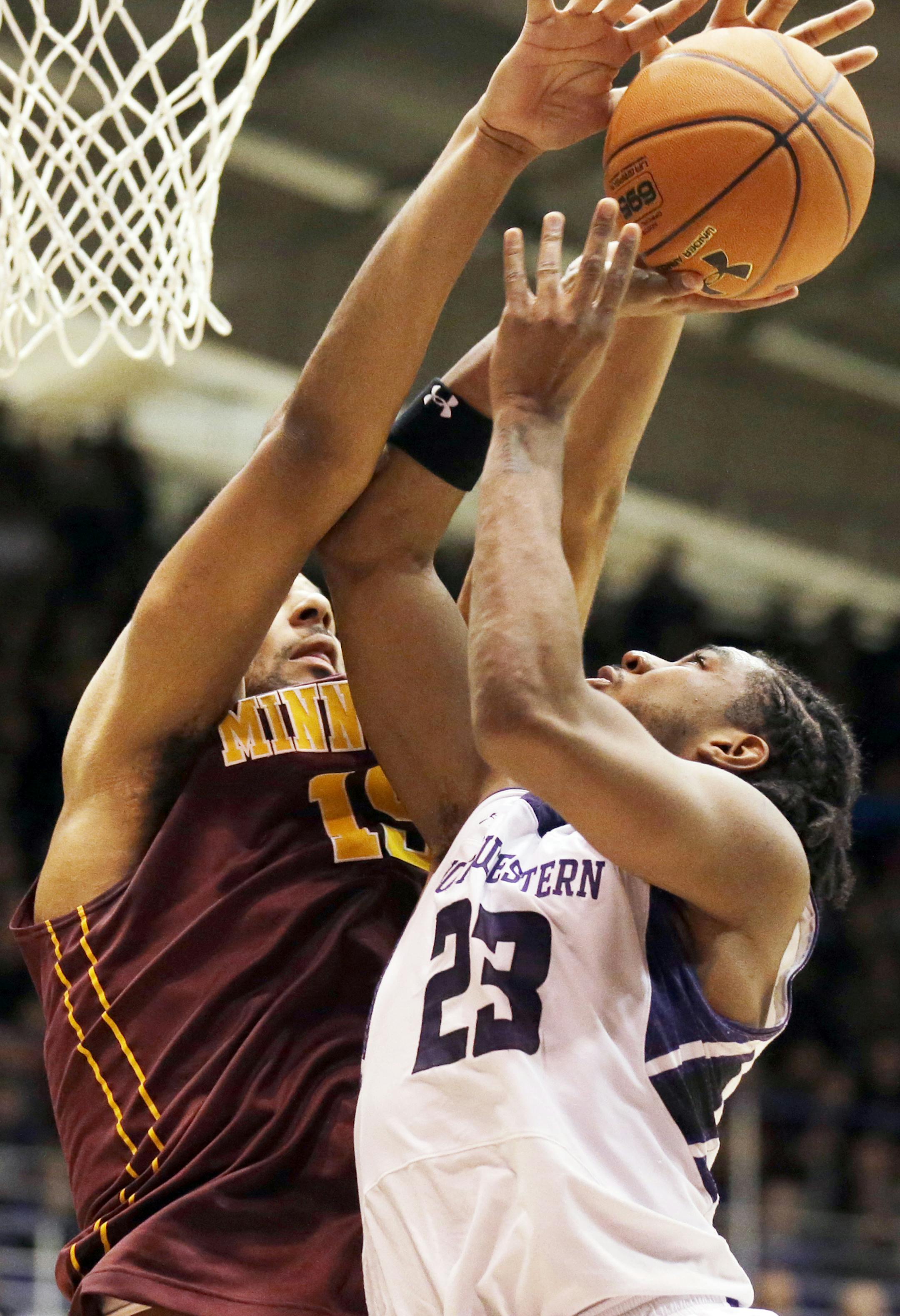 Minnesota forward Maurice Walker, left, blocks a shot by Northwestern guard JerShon Cobb during the second half of an NCAA college basketball game in Evanston, Ill., Sunday, Feb. 16, 2014. Minnesota won 54-48. (AP Photo/Nam Y. Huh)