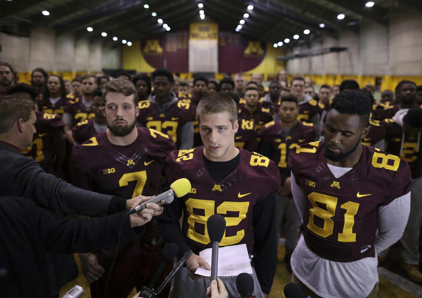 Gophers wide receiver Drew Wolitarsky, center, flanked by quarterback Mitch Leidner, left, and tight end Duke Anyanwu, read the statement on behalf of all the players.