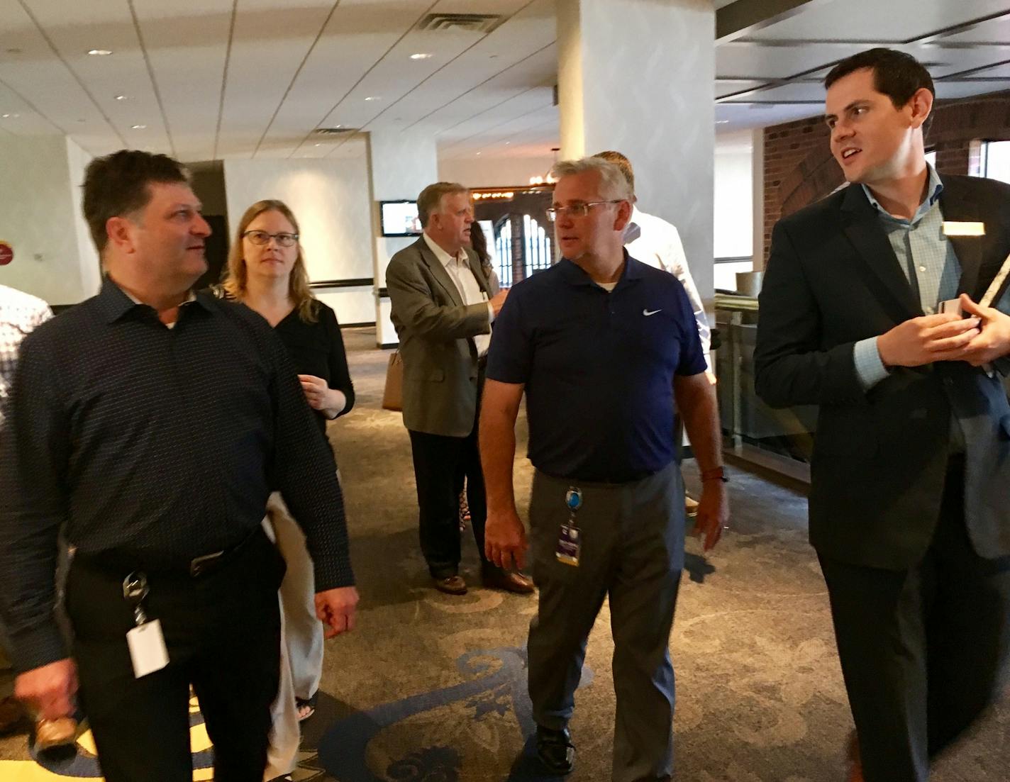 Paul Almen, left, and Gregg Johnson, middle, led a tour of a venue for a upcoming event with Commons Hotel catering sales manager, Kyle Heidelberger, right.